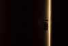 Door in a dark room, ajar. Light coming from beyond the door. Door in a dark room, ajar. Light coming from beyond the door.